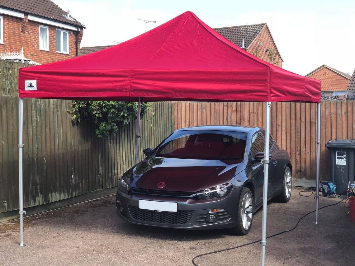 Red Pop-up Gazebo covering a vehicle