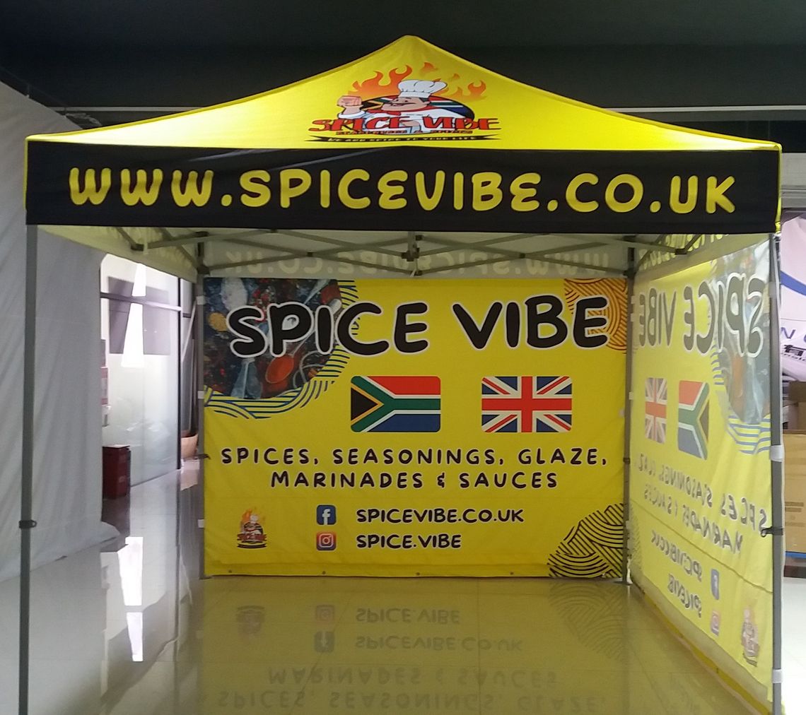 A yellow Gala Shade Pop Up Gazebo with custom branding to be used as a pop-up market stall